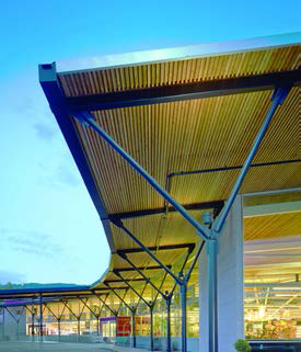 The unified wooden canopy expresses the central role of forestry and community in the culture of the region. The building takes a vacant lot in a typical commercial strip and reimagines it as an urban space, with a mix of housing, office and commercial use on site.